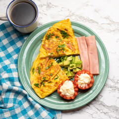 Ham omelette with avocado and tomato