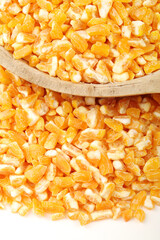 raw crushed corn groats close up