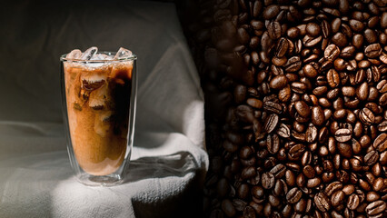 Ice coffee on a white background with cream being poured into it showing the texture and refreshing look of the drink
