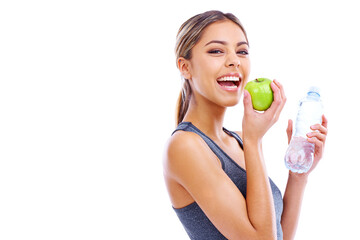 Her secrets to vitality. Portrait of a sporty young woman holding an apple and a bottle of water...