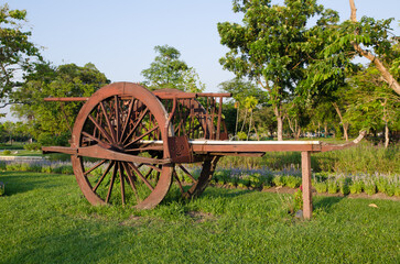 Thai traditional wooden cart using as a public park decoration in Thailand.