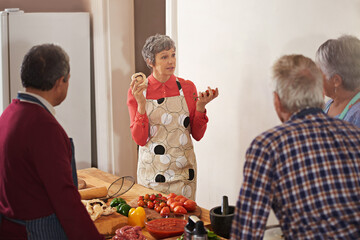 Good health is in the cooking. Shot of a woman instructing a cooking class.