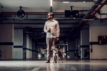 Fototapeta premium A man with a dog in the garage.