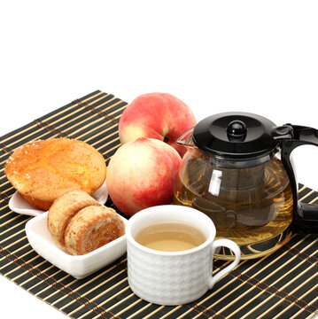 cake,cup and teapot of tea on white background