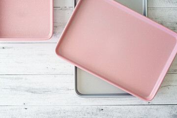 Cookie sheets close up on light wooden background directly from above with copy space
