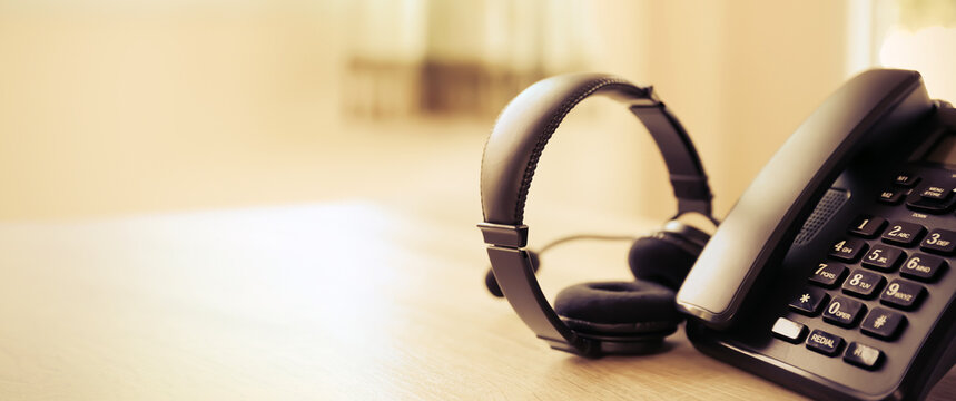 Customer service concept. Close-up headphone and telephone for communication helpdesk IT support or call center and online services.