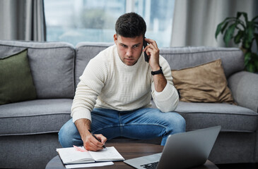 You can stay in one spot and still keep it moving. Shot of a young man using a laptop and smartphone while writing in a notebook at home.