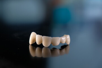 Dental ceramic bridge on isolated wite background. Metal free ceramic dental crowns