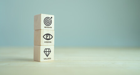 Mission, vision and values of company. Purpose business concept. The wooden cube with mission, vision and values symbols on grey background, copy space. Modern stacking design. Business presentation. - obrazy, fototapety, plakaty