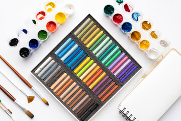 Flat composition set of artistic tools. Brushes, paints, pencils, pastels for drawing. Place for text.