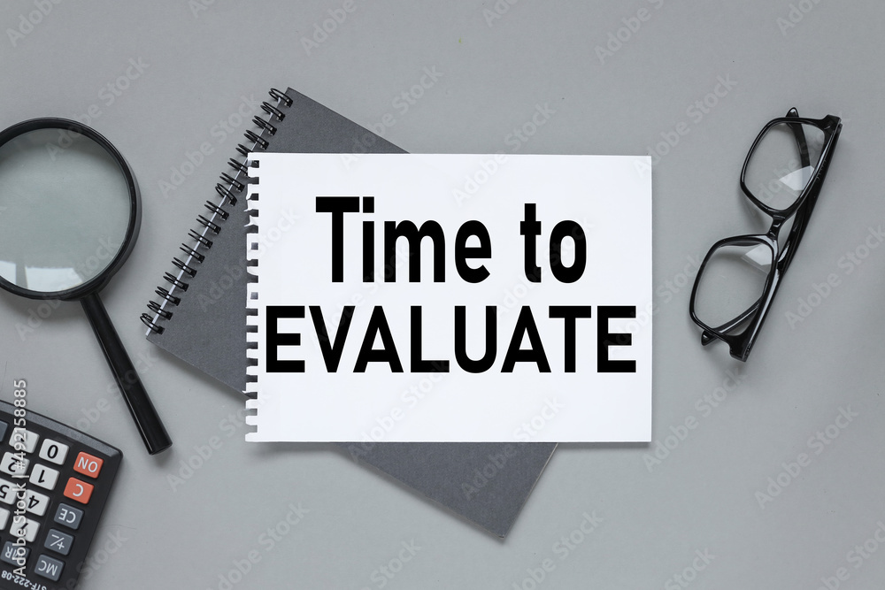 Poster time for evaluate, gray background. two notepads. kind of swedhu. text on a notepad page.