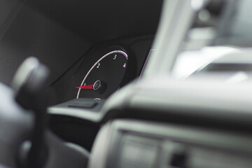 soft focus. natural light. the dashboard. the arrow shows the engine speed. there is a tinting.