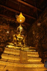 The Golden Buddha image Phra Sri Sakyamuni in the main chapel of Wat Suthat Thepwararam. Located in Bangkok, THAILAND.