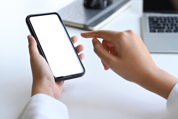 Businesswoman hand holding and pointing on screen of smart phone.