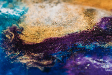 Ink background. Abstract colorful design. Creative paint mixture. Purple beige blue colors blend