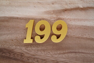 Golden Arabic numerals on real wood with brown and white pattern.