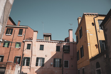 Fototapeta na wymiar View on the popular Venetian houses. Old colorful buildings against the blue sky.