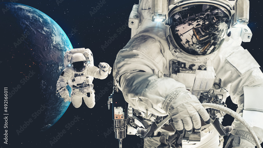 Wall mural astronaut spaceman do spacewalk while working for spaceflight mission at space station . astronaut w