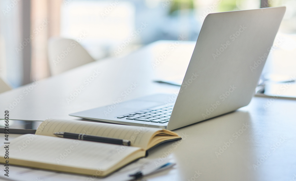 Poster theres lots to plan if you want to succeed. closeup shot of a laptop and notebook on a desk in an of