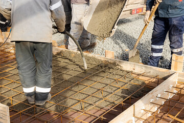 Pouring cement or concrete with a concrete mixer truck, construction site with a reinforced...