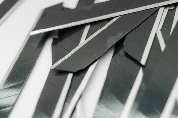 New black blades for stationery knife. A pack of spare stationery blades. Selective focus, copy space