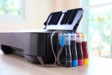Close up printer with ink tank on the office desk. Concept of copier or photocopier workplace...