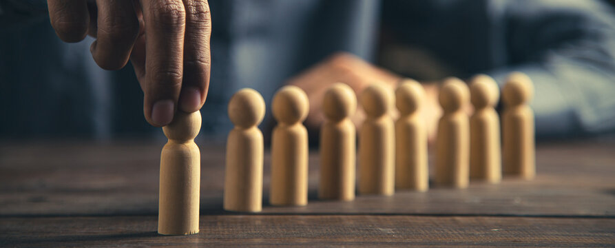 Hand choose person wooden doll concept of leadership and business team creative thinking and human resources for teamwork or team player.
