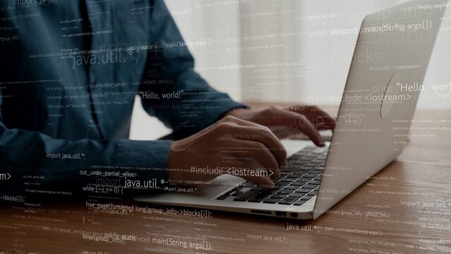 Computer programmer uses capable laptop computer to develop programming code of new software . Computer specialist working on future coding application for software programming development .