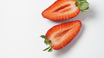 Sweet fresh strawberry halves cut on white background