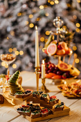 Blurred image of different types of bruschetta with cheese and fruits in a cardboard box. Takeaway food concept.