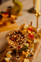 Nuts mix in a wooden plate. Catering Service Photography