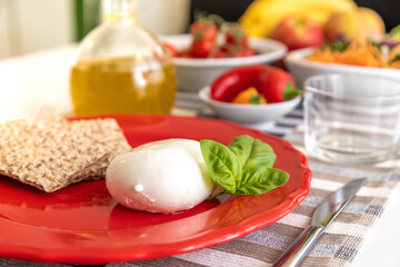 Nutritious dishes prepared with mozzarella salad and tomatoes. Natural and healthy ingredients of the Mediterranean diet: olive oil, cereals, peppers, vegetables, fruit and cheese. Farmers products