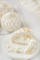 meringue on a white plate on white background