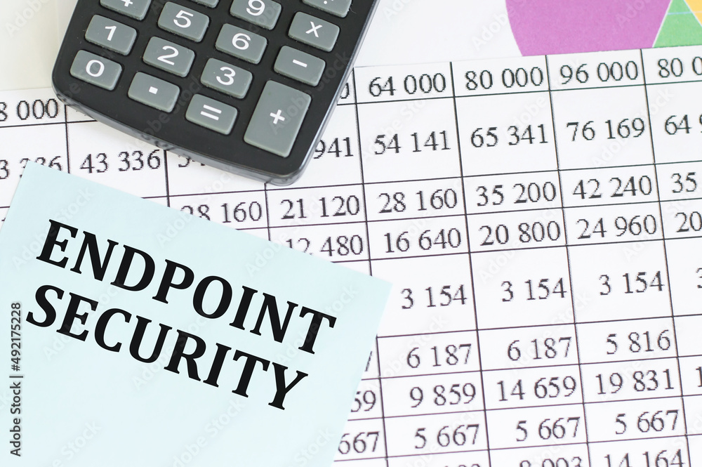 Aufkleber business concept. text endpoint security on a blue card in the background of reports on the table