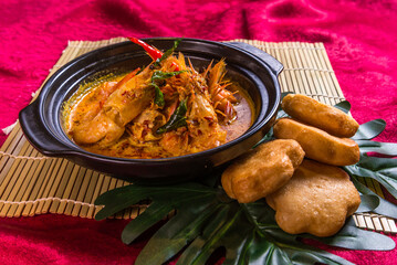 braised tiger big prawn with Indonesia curry soup in hot clay pot and deep fried mantou bun restaurant chinese banquet halal food asian cafe menu