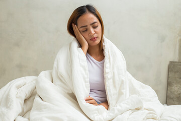 Asian woman feeling sick problems fever and cough sleeping on bed at home

