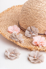 Fabric flowers and a straw hat. Flowers for creativity and sewing