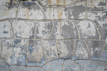 Texture map. stone-look concrete wall with peeling paint. Selective Focus. Copy Space 