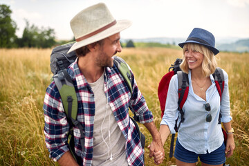 Loving embracing man and woman having fun in the nature..Holidays, vacation and friendship concept.