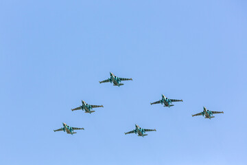aviation group of the russian military jetfighters in the air against the blue sky.