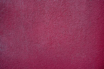 Dark pink or purple, textured smooth concrete wall. 3D design background or surface.
