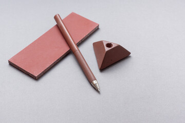 Red pen and gypsum sample on gray background. Space for text