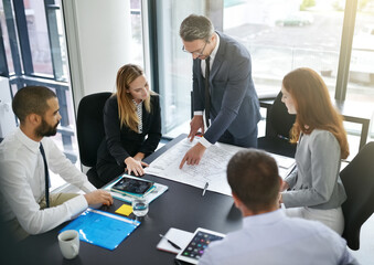 Going over the details. Cropped shot of businesspeople in a meeting.