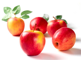 Bright apples with leaves on a white background