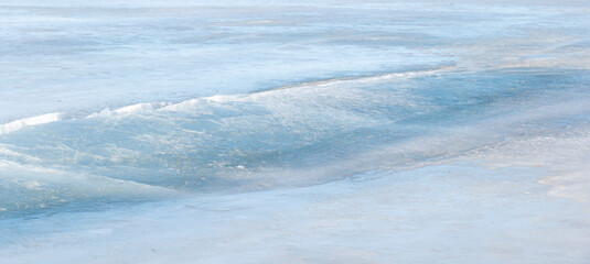 Texture of winter ice surface. Blue natural ice background.