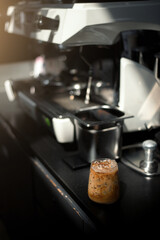 Ice coffee on a black table with cream being poured into it showing the texture and refreshing look of the drink
