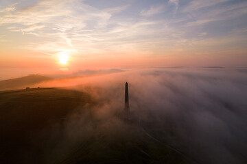 sunrise over a monument and field