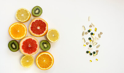 fresh natural fruits vs pills. Natural vitamin in fruits vs synthetic vitamin in pills. Choice between natural and synthetic way of health care. Alternative medicine.