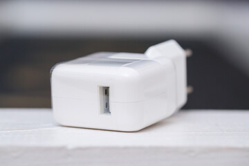 White USB charger for gadgets and mobile phones. Charging from the mains for the phone