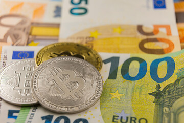 bitcoin on euro banknotes close-up